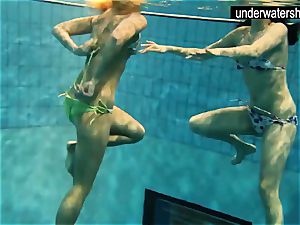 2 cool amateurs demonstrating their bodies off under water